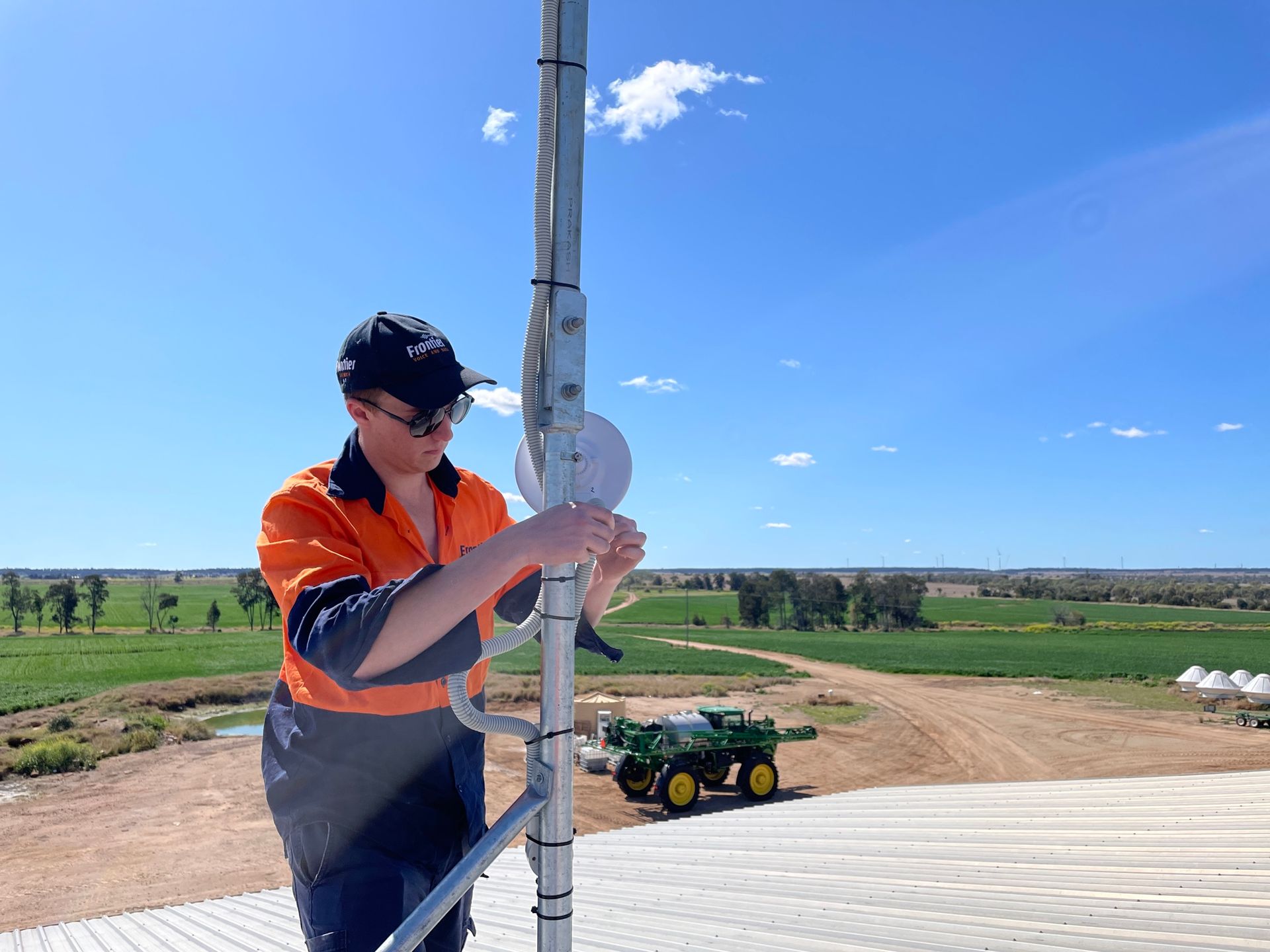 Licensed technician setting up a security camera mast