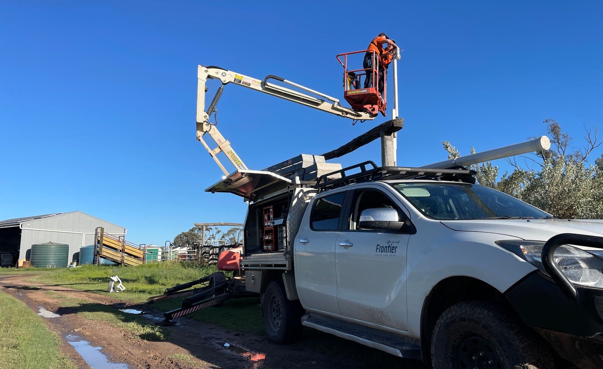 Frontier Security technicians working from an EWP lift