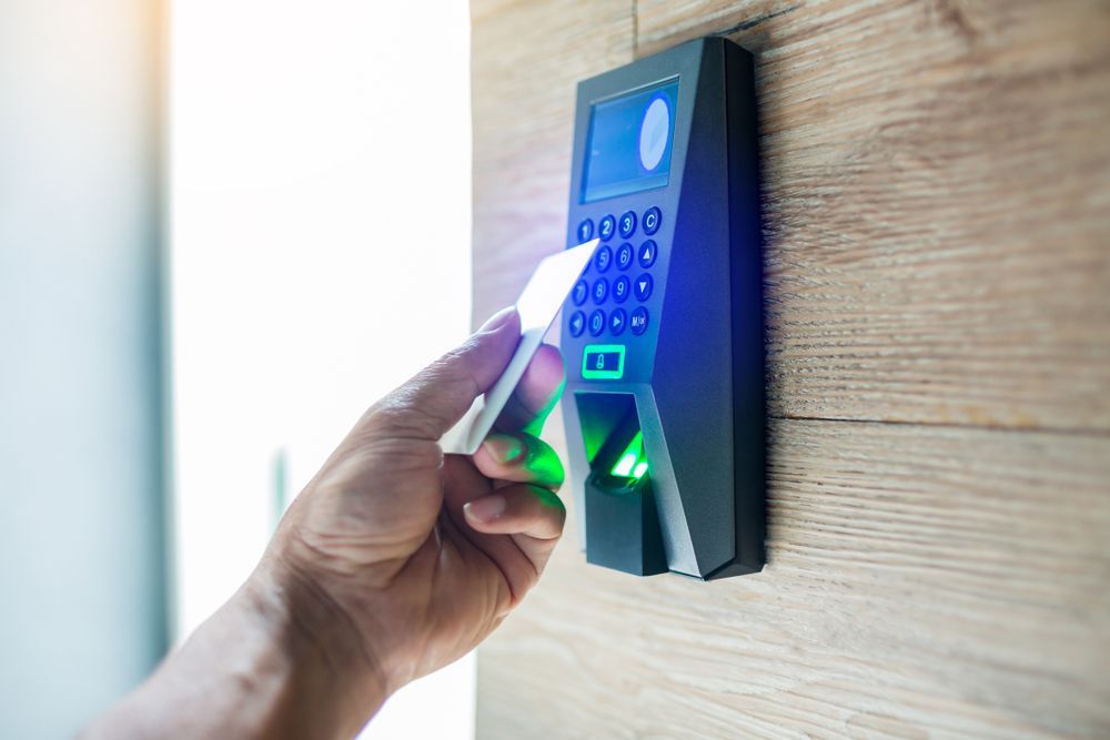 Person swiping an access card on a door security system